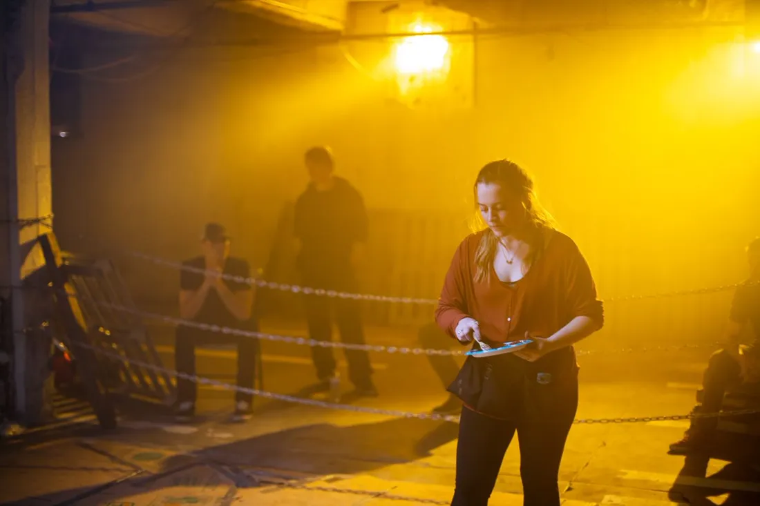 Actor in amber haze during a night film shoot