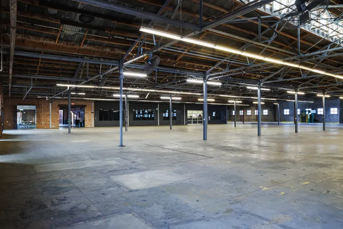 The Grand — raw, open, column-free space under steel trusses