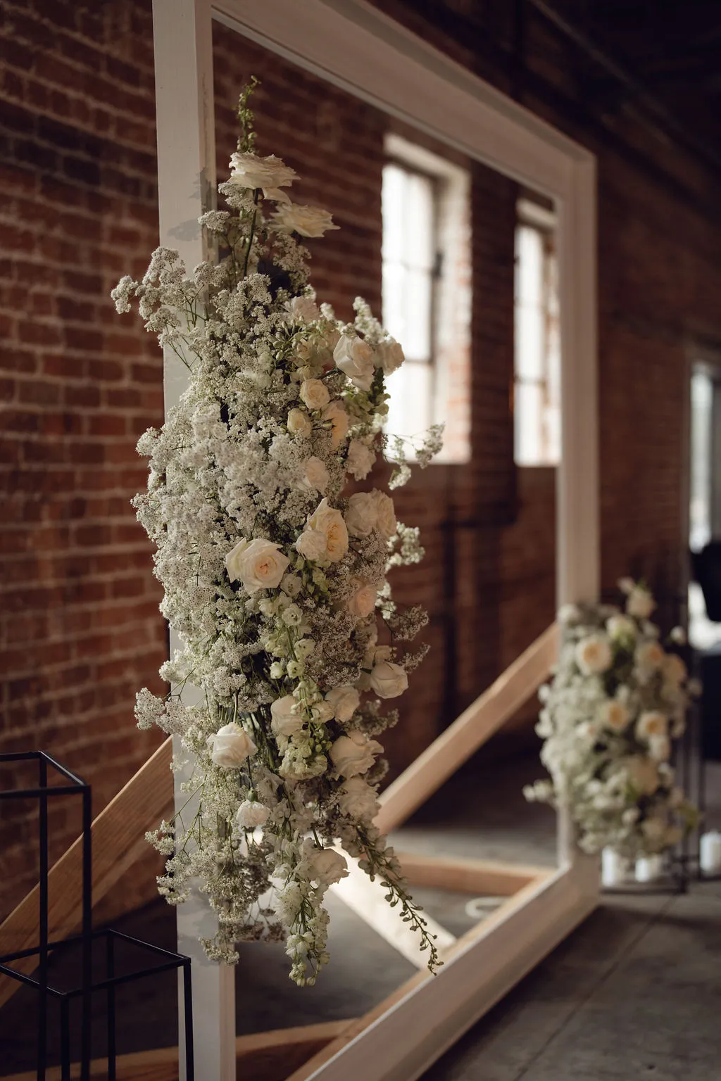 White floral installation on a freestanding frame